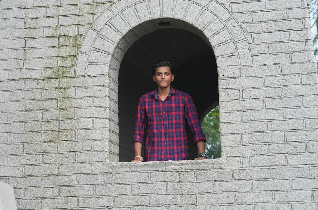 Portrait of a smiling man with short dark hair in a casual shirt